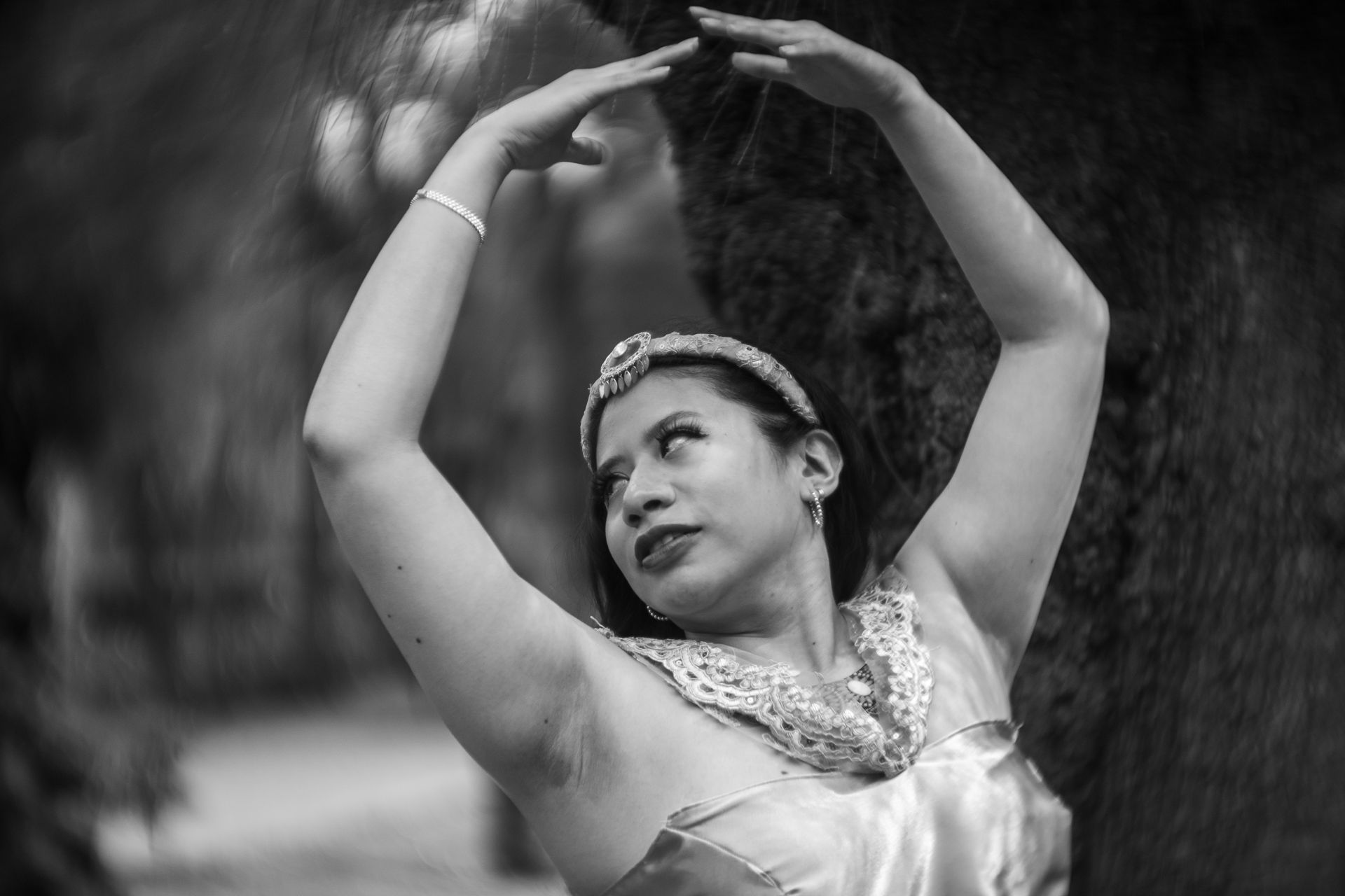 Black and white photo of a woman posing gracefully in a princess costume outdoors in Mexico City.