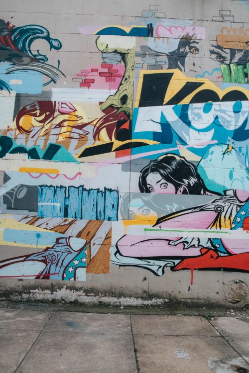 Free Colorful graffiti mural featuring various artistic elements on a street wall in Richmond, VA. Stock Photo