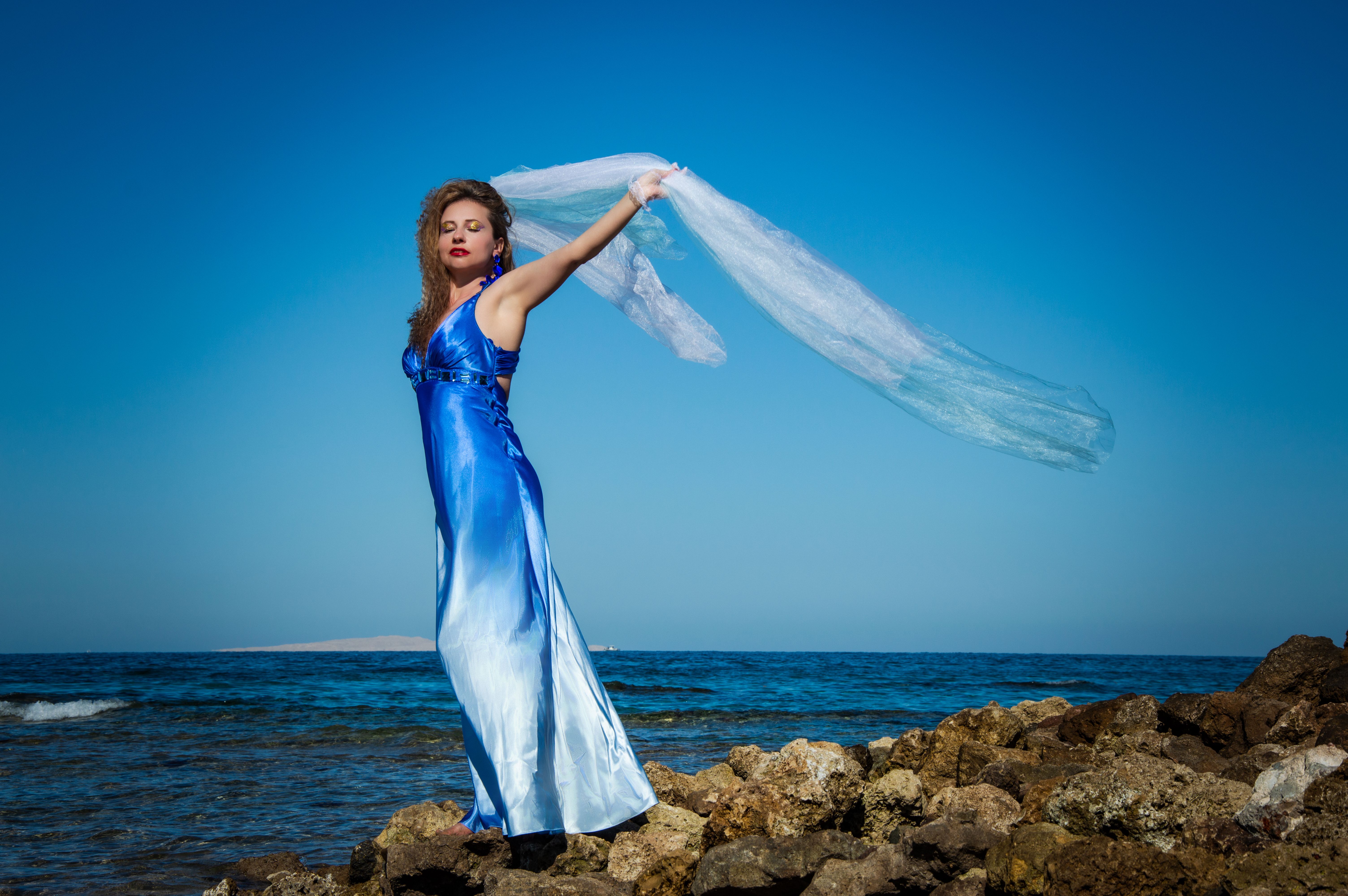 Elegant Woman in Blue Dress by the Sea Shore · Free Stock Photo
