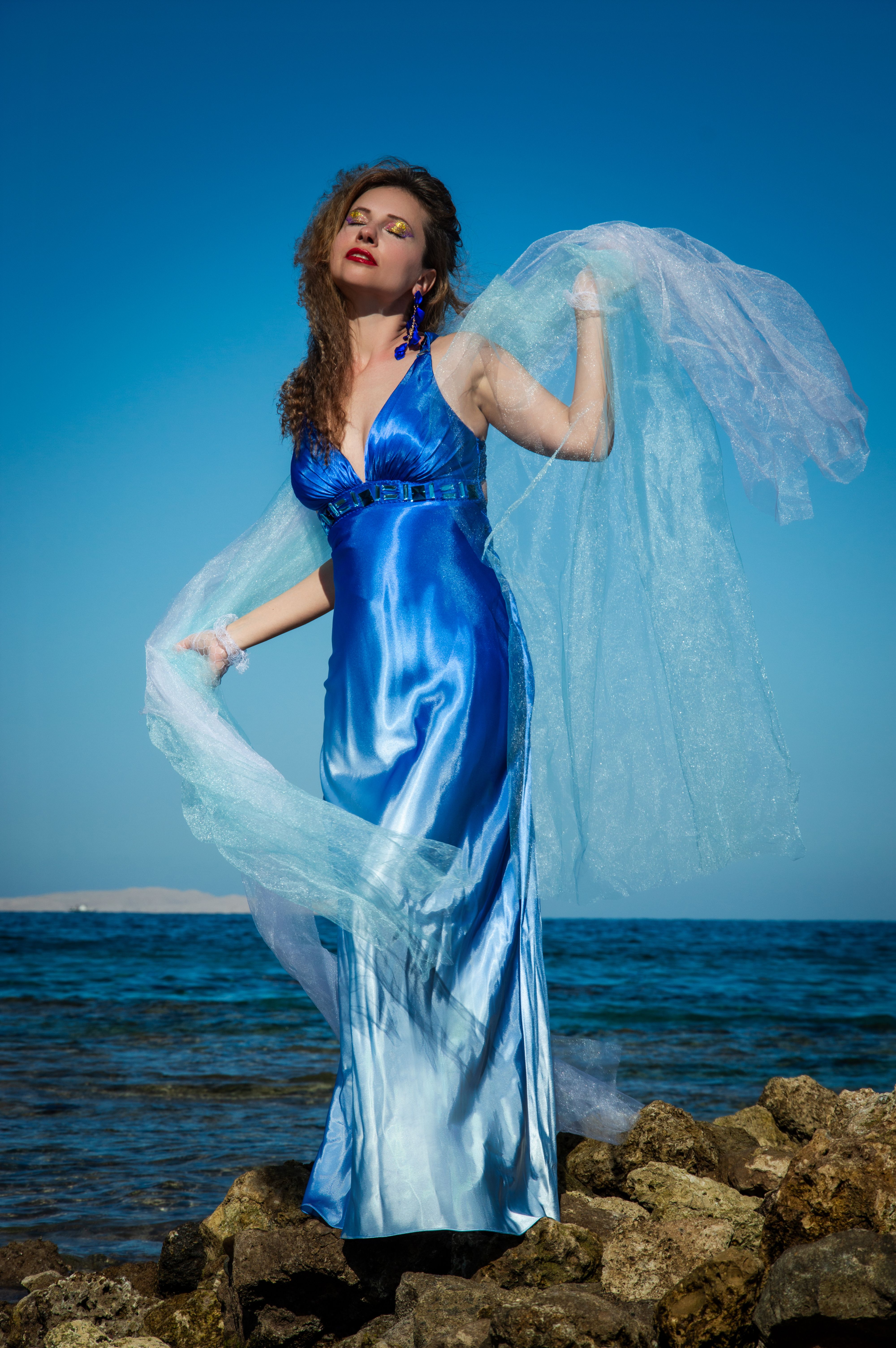 Elegant Woman in Blue Dress by the Sea · Free Stock Photo