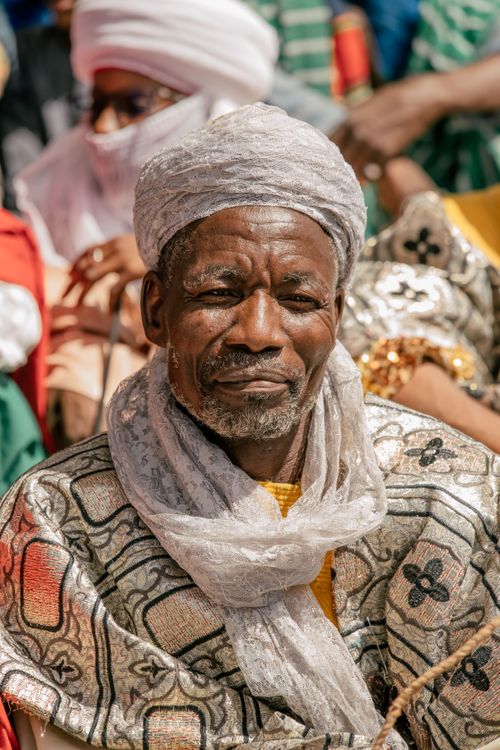 Free Portrait of an elderly man wearing traditional African clothing at a cultural event. Stock Photo