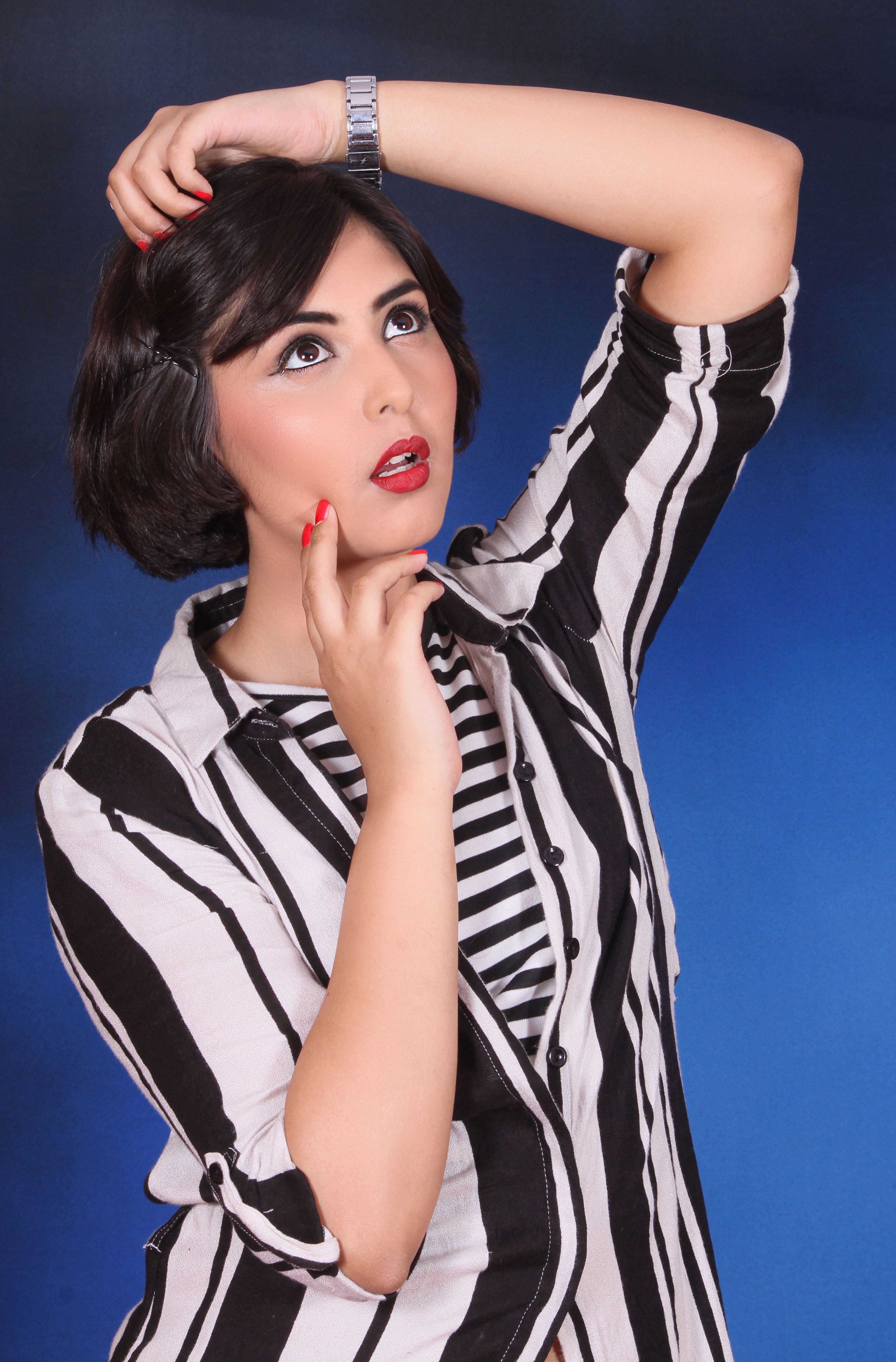 Fashion Portrait of a Woman in Striped Attire · Free Stock Photo