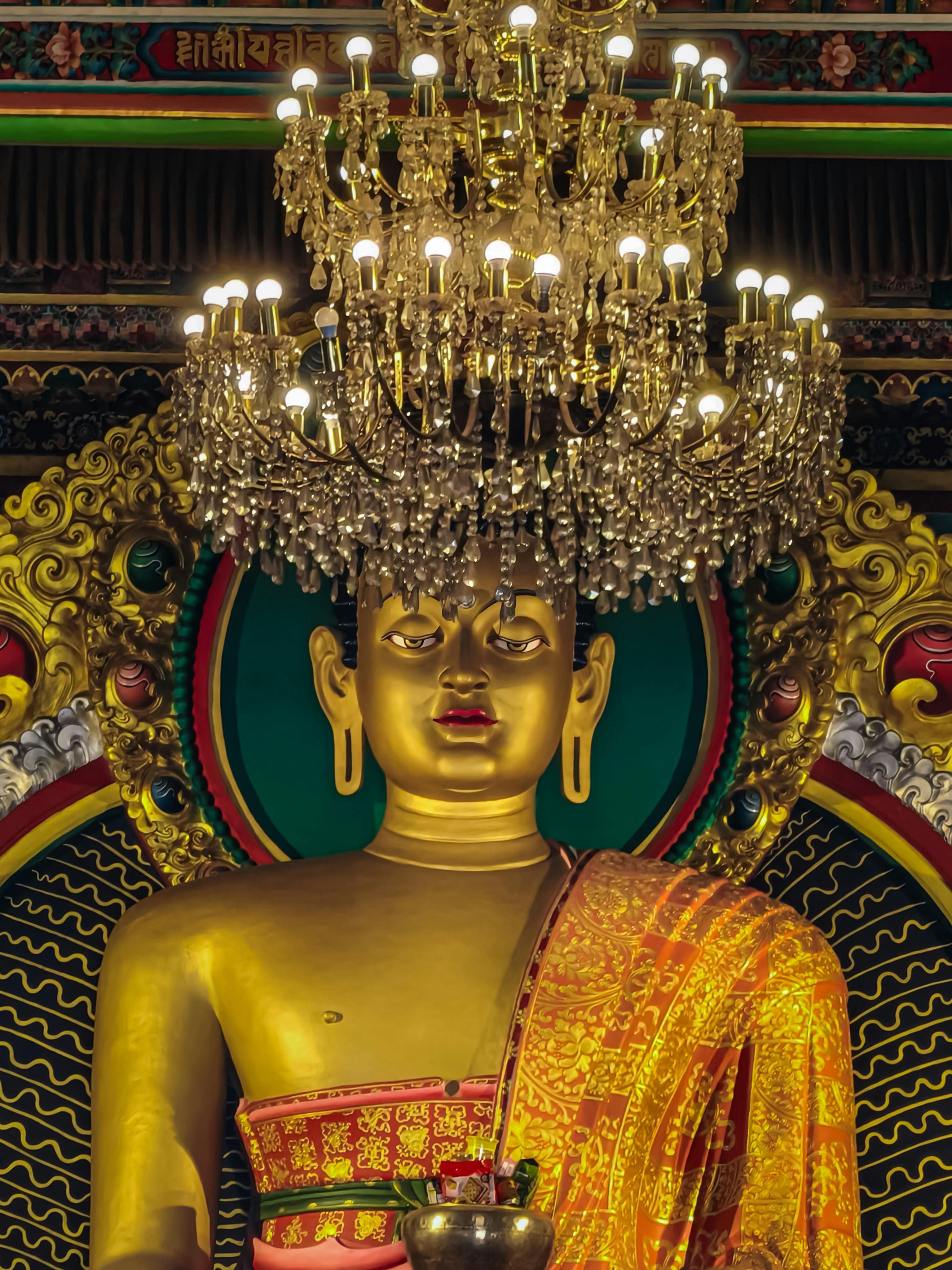 Golden Buddha Statue with Intricate Chandelier · Free Stock Golden Buddha Statue with Intricate Chandelier · Free Stock