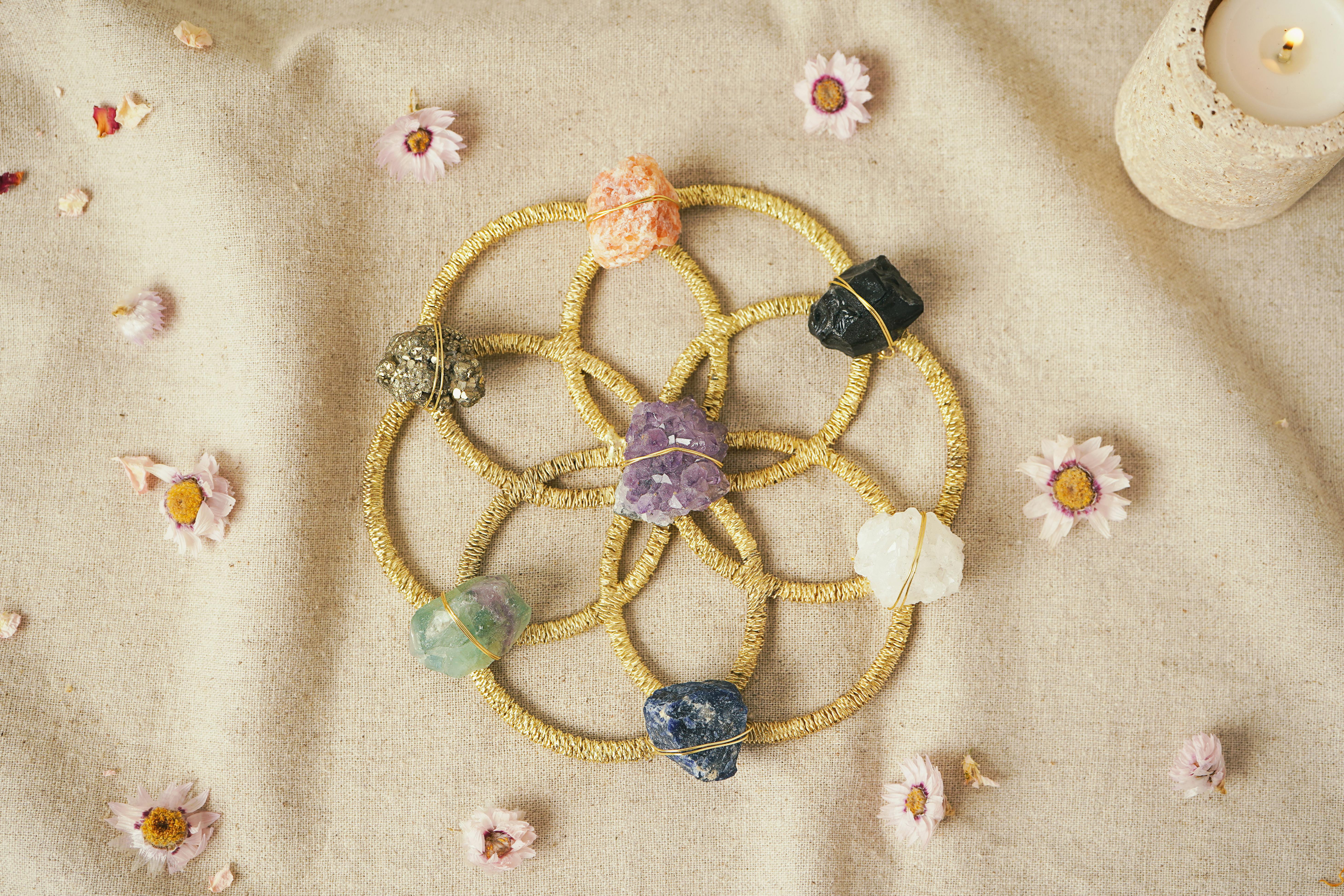 crystal grid with flowers and candle