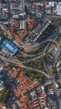 Dynamic aerial view of intricate urban street networks and vibrant city buildings.