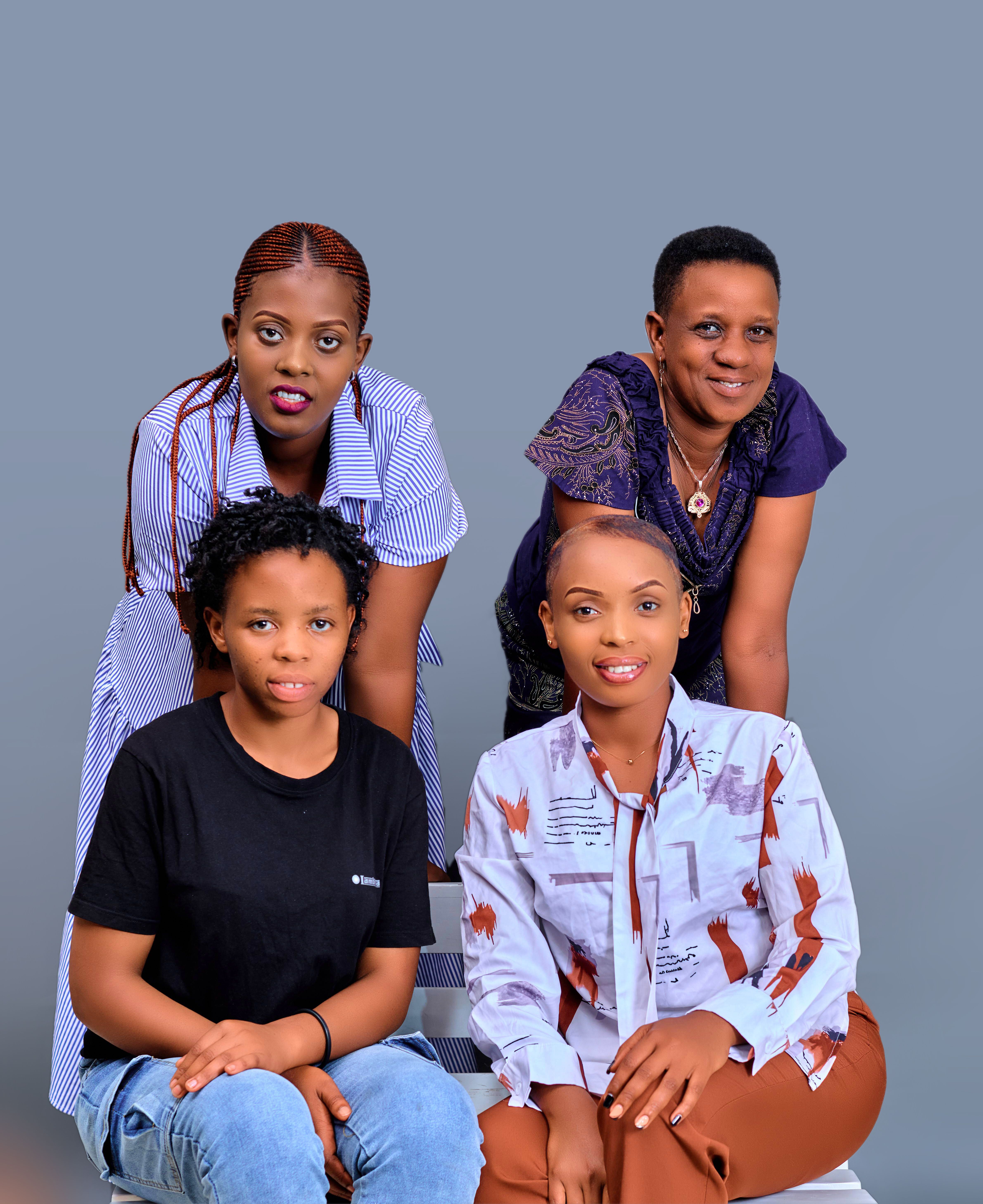 Vibrant group portrait of four smiling women, showcasing friendship and diversity in Kigali, Rwanda.