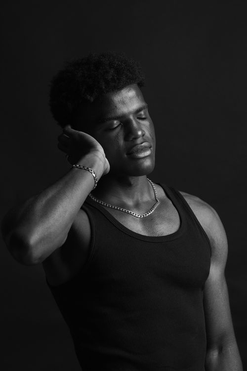 Free Calm and serene black and white portrait of a relaxed male model in a studio setting. Stock Photo
