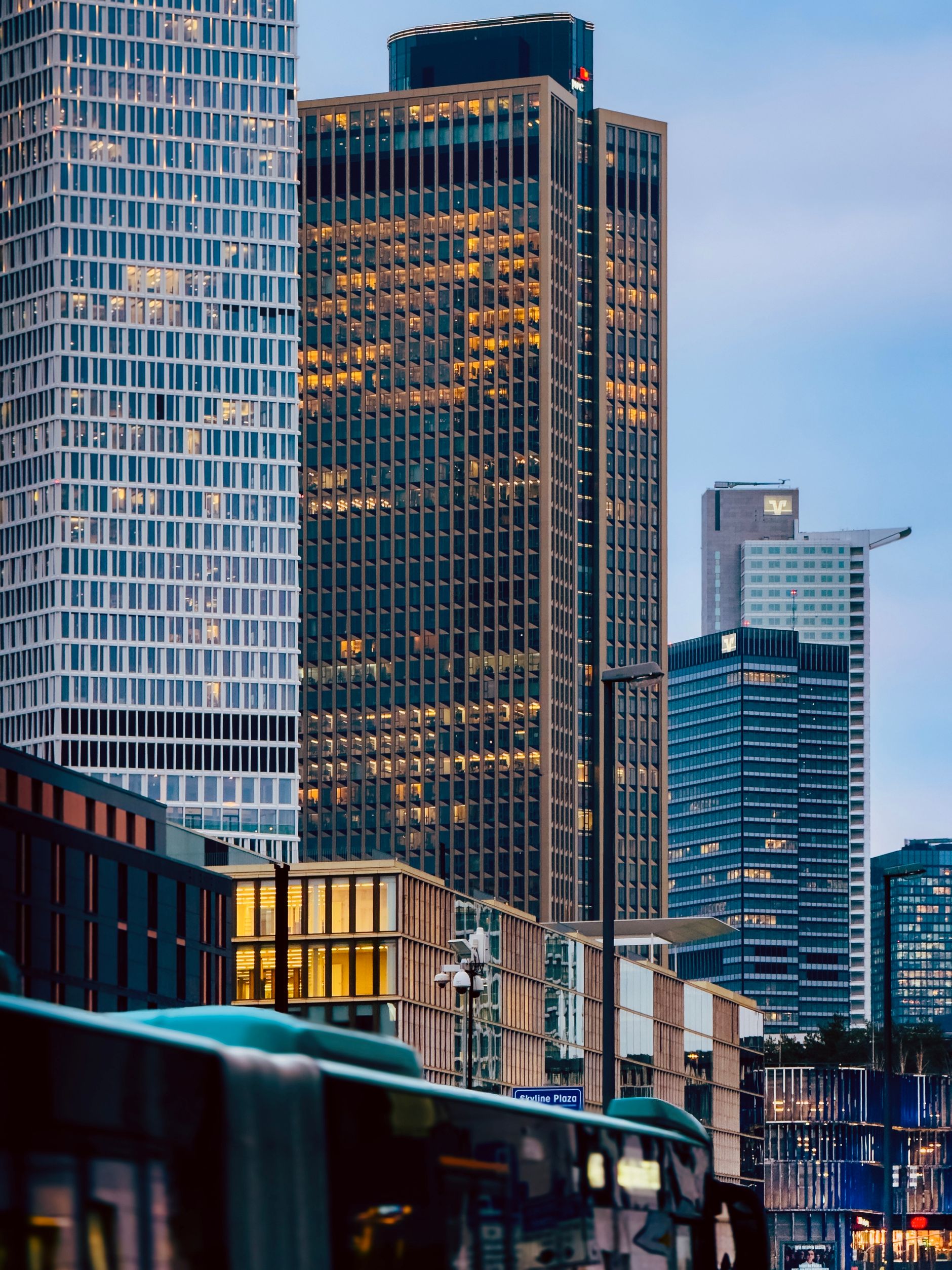 A financial district skyline of glass skyscrapers at twilight