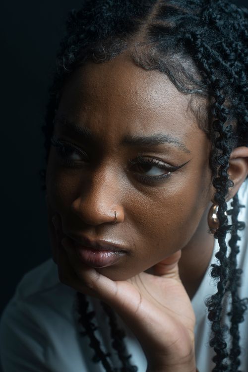 Free Close-up portrait of a thoughtful woman with braided hair in Berlin. Stock Photo