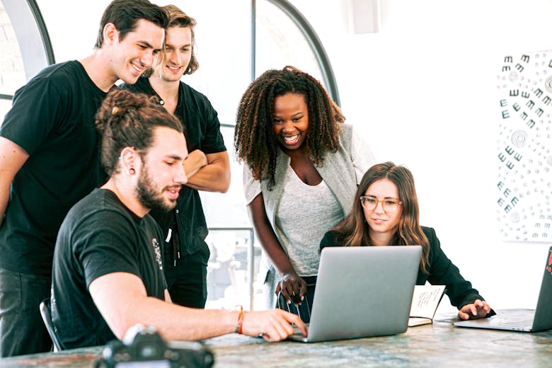 Diverse business team collaborating in an office, representing networking and outreach