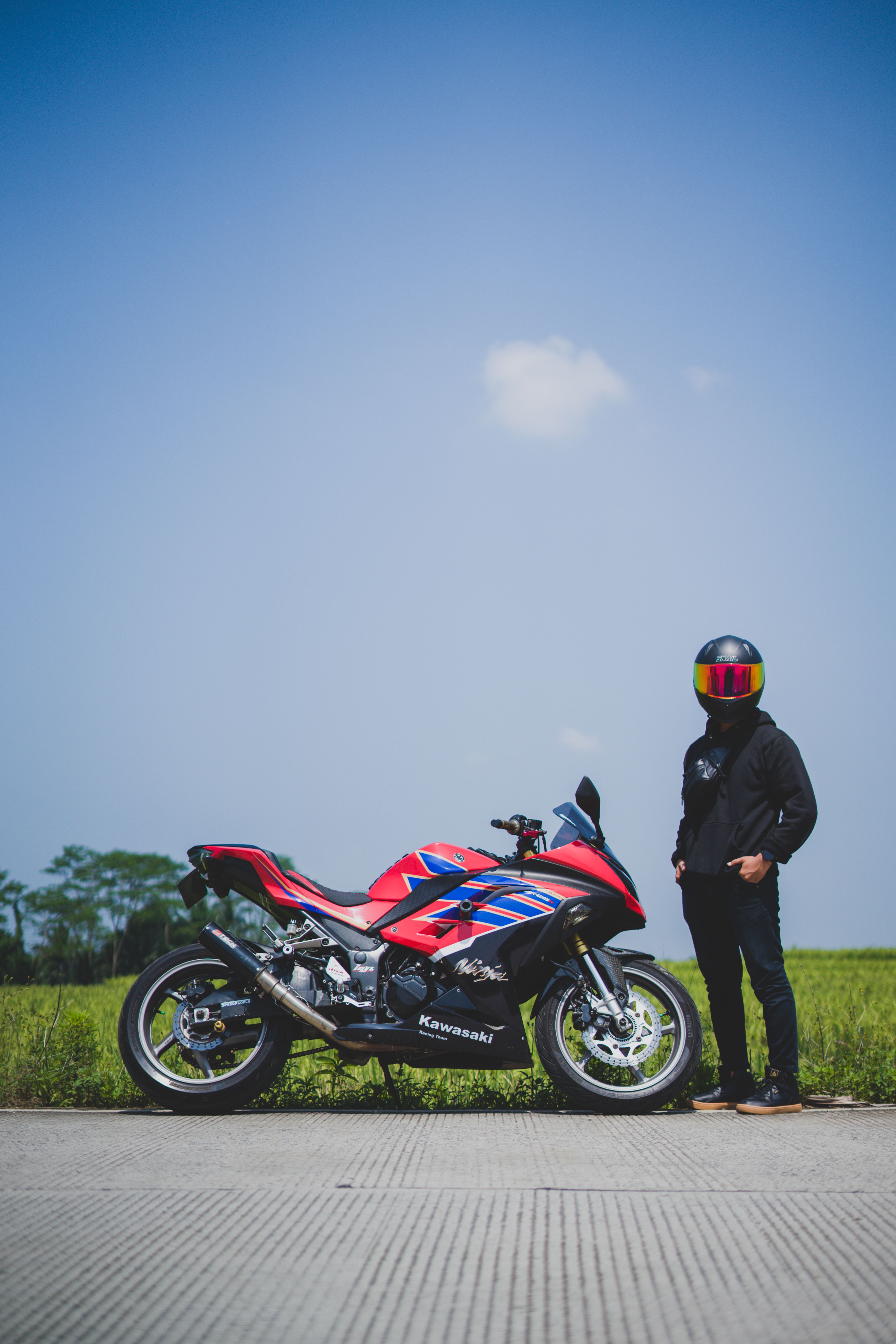Red Sports Motorcycle with Rider in Open Landscape · Free Stock Photo