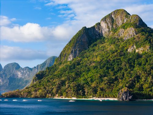 Free Explore El Nido's stunning karst landscape with lush greenery and blue seas, showcasing the beauty of Palawan, Philippines. Stock Photo