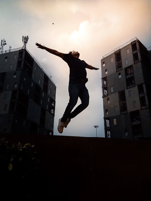 Free Person Jumping With Arms Wide Open Stock Photo