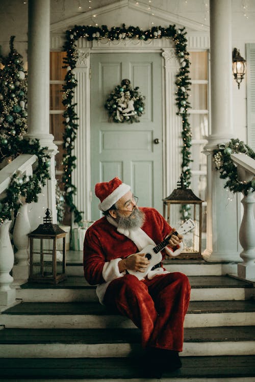 Man In Santa Claus Costume sitting  on The door way