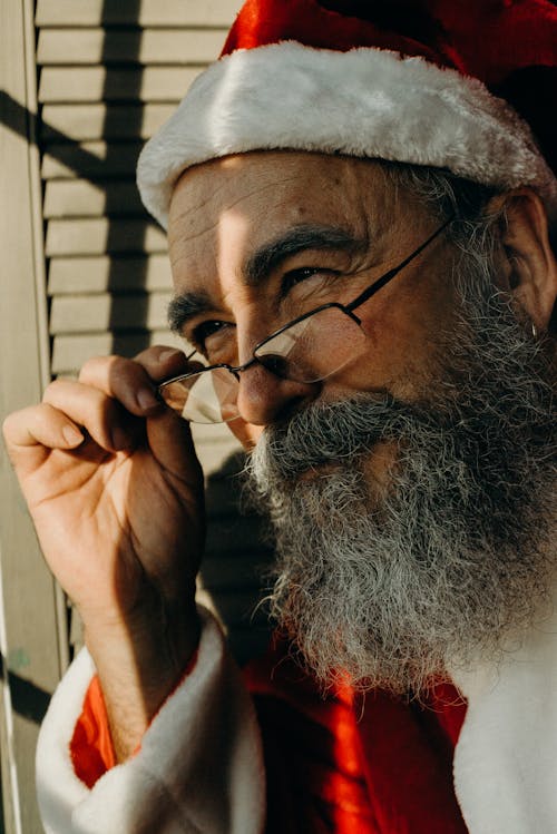 Close Up Photo of a Man Wearing Santa Costume