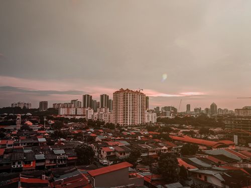 Free A cityscape at dusk showcasing buildings under a warm sky. Stock Photo