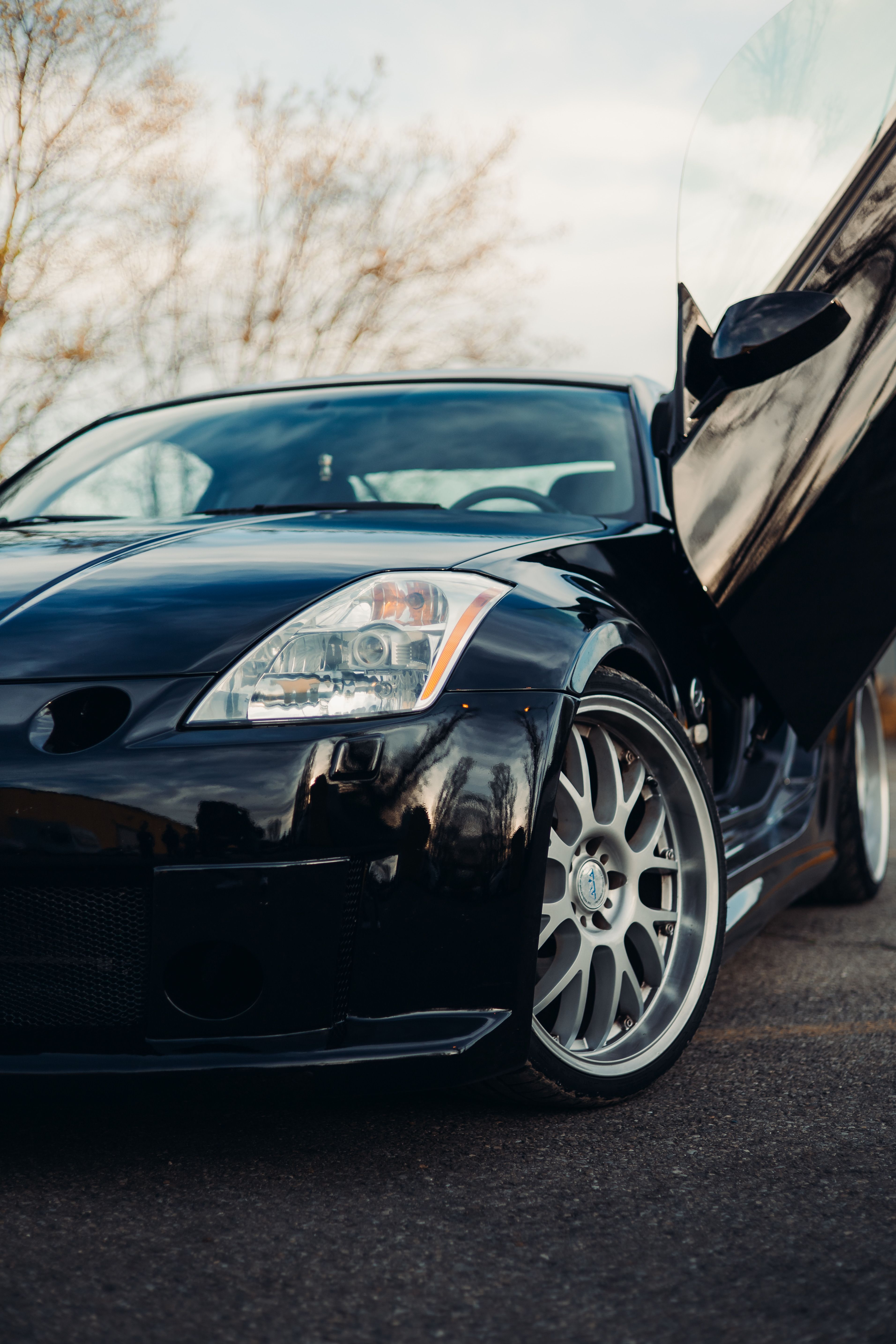 Black sports car with open door outdoor · Free Stock Photo
