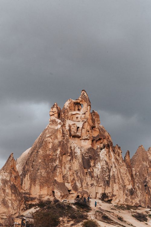 Free Stunning Cappadocia landscape with unique rock formations under a dramatic sky. Stock Photo