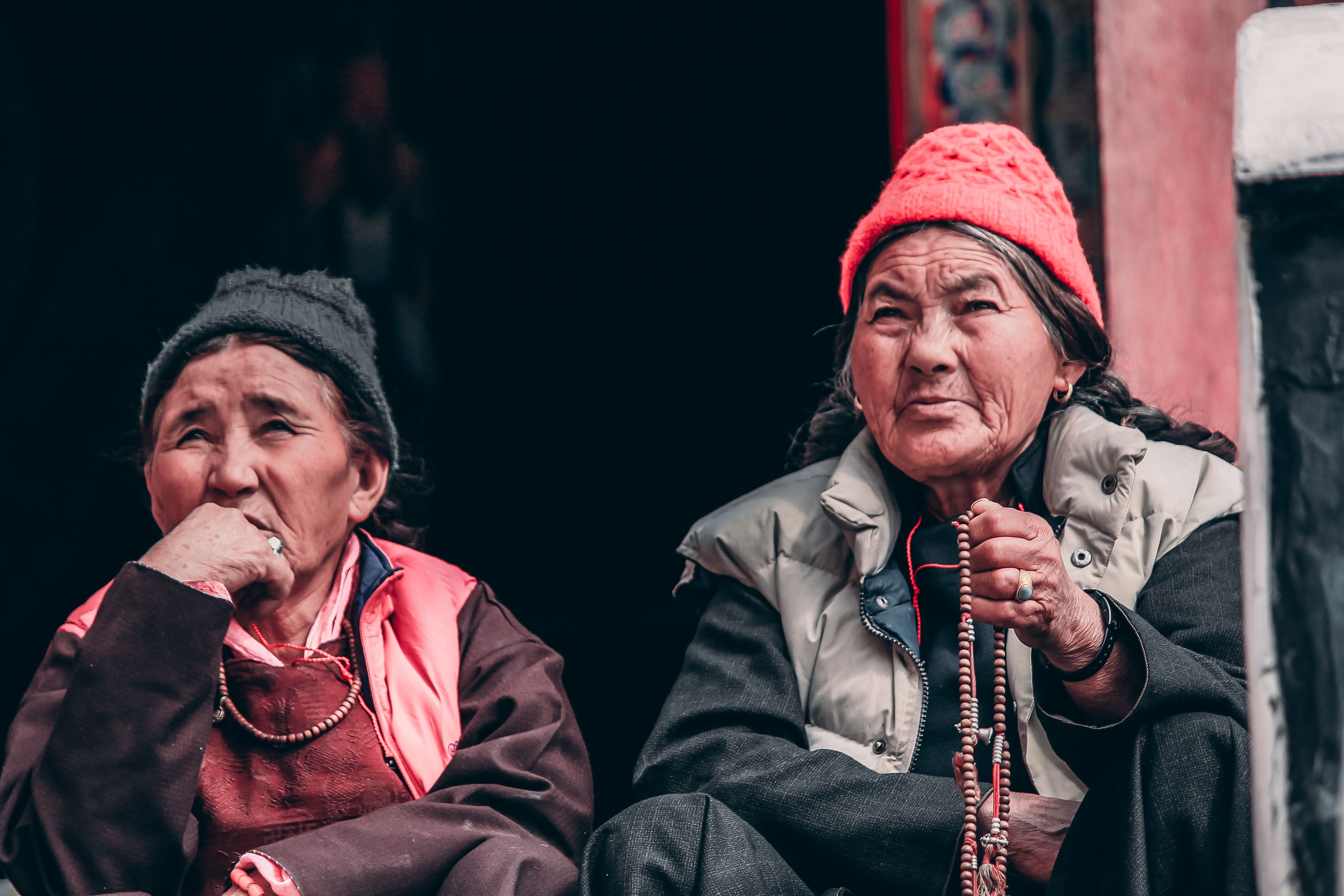 Elderly Women with Prayer Beads in Traditional Attire · Free Stock Photo
