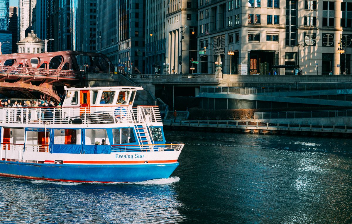 A Chicago River architecture cruise boat passing downtown skyscrapers