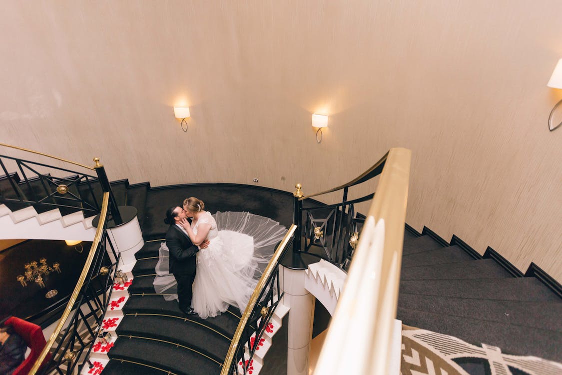 Free stock photo of bride and groom, bride and groom kissing, kissing on the stairs Stock Photo