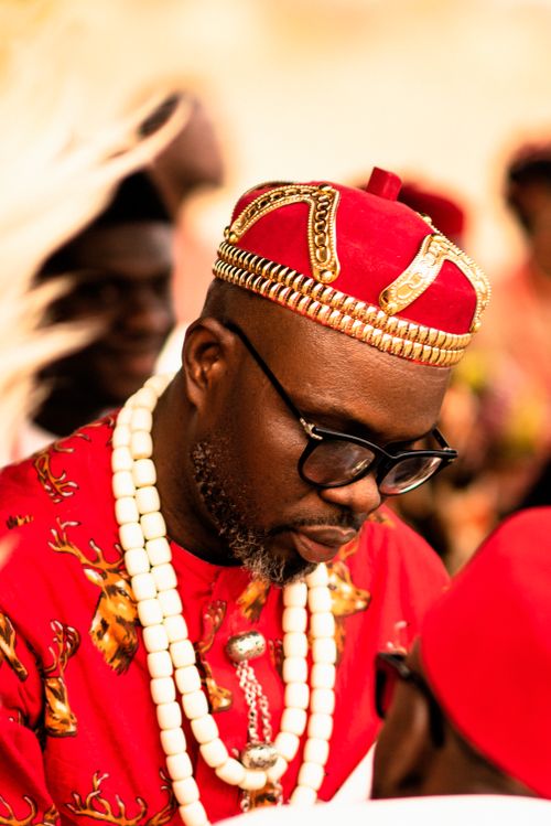 Free Portrait of an African man wearing traditional Igbo clothing, immersed in thought. Stock Photo