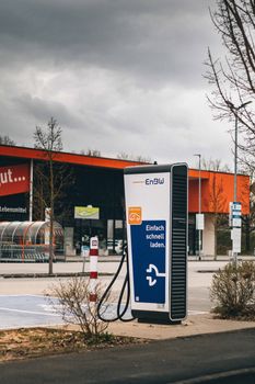 EV charging station outside a supermarket, showcasing modern infrastructure for sustainable travel. - Fotografer Sidoarjo