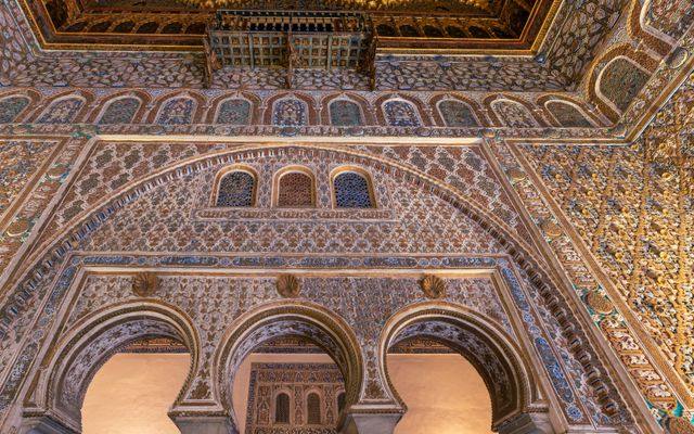 Photo: Ramon Perucho on Pexels Explore the ornamental arches and ceilings of Seville's Real Alcázar, showcasing stunning Mudéjar architecture.