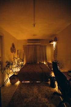 This serene bedroom showcases a warm ambiance with cozy lighting, perfect for relaxation and comfort.