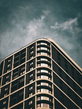 Sharp angle view of a modern building against a dramatic sky in Ankara, Türkiye.