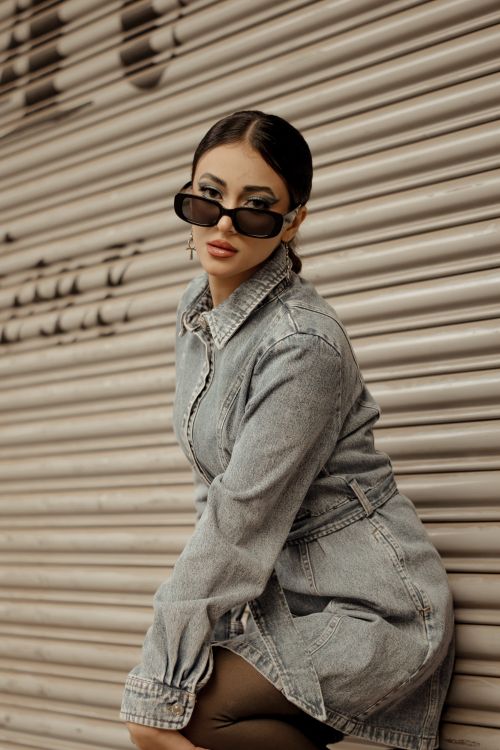 Free Young woman in denim dress with sunglasses in urban setting, Cairo, Egypt. Stock Photo