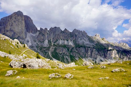 Free Stunning view of the Dolomites with rocky peaks and grassy foreground under a cloudy sky. Stock Photo
