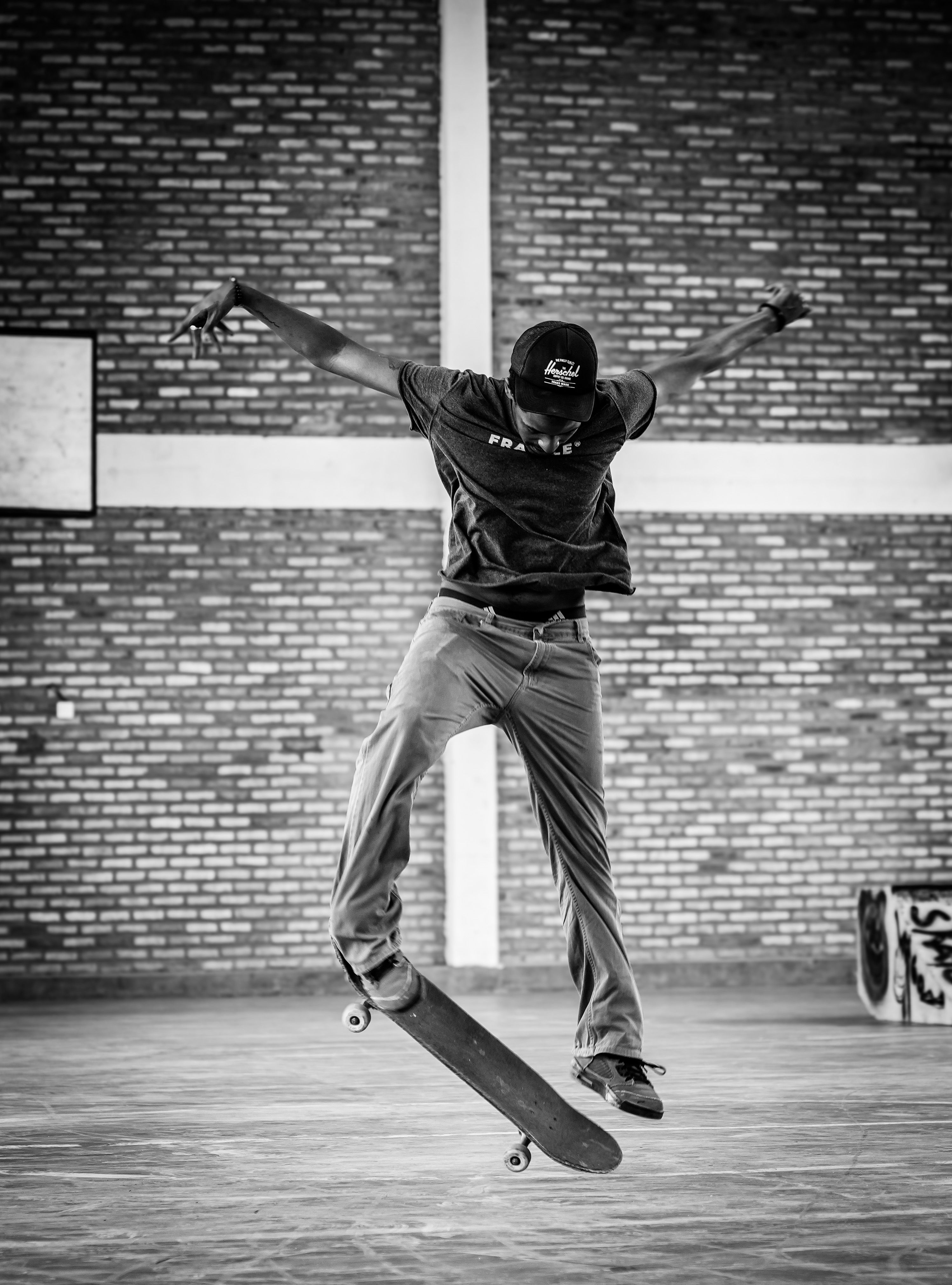 A young skateboarder captures air indoors in Rwanda, showcasing urban talent.. young, skateboarder, captures