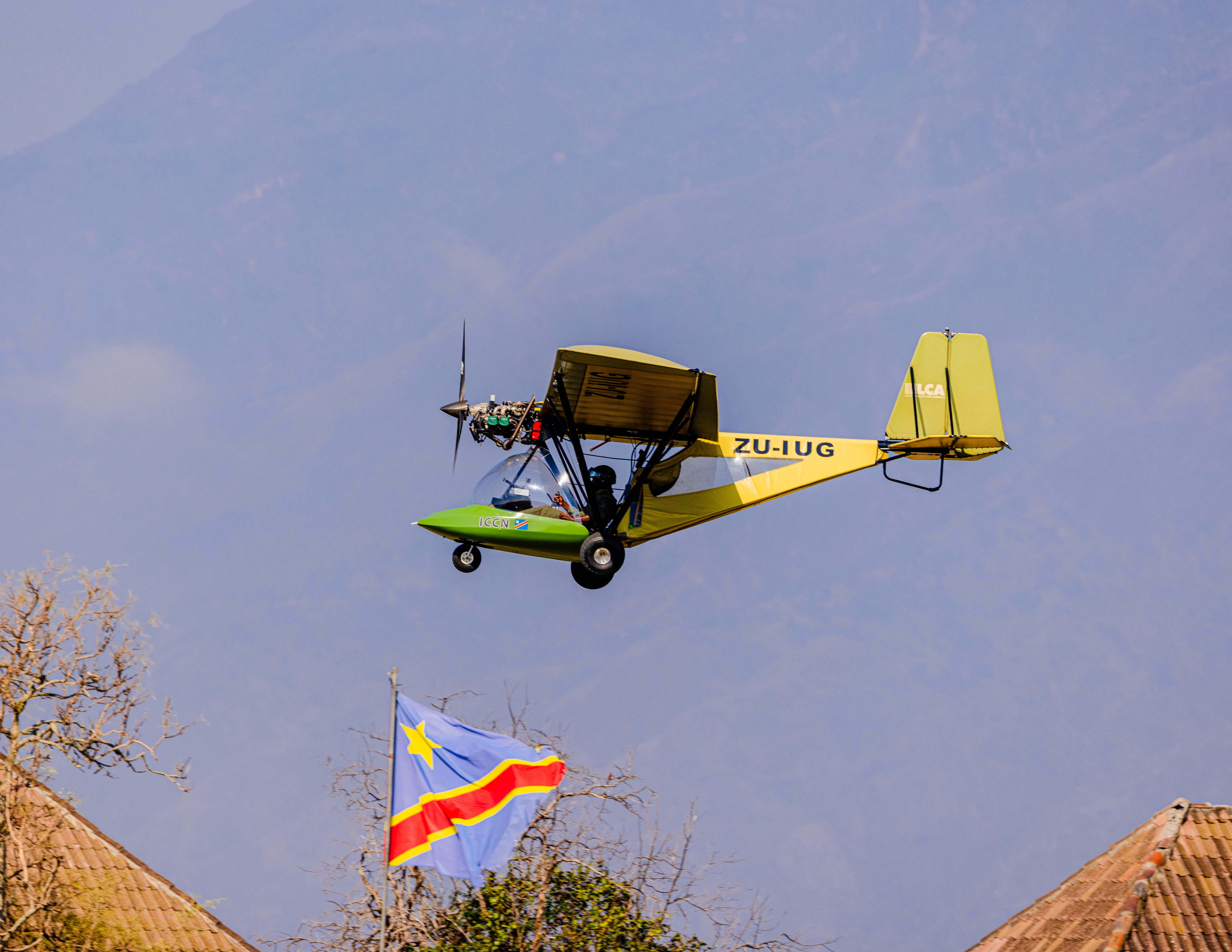 Ultralight Aircraft Soars over DRC Landscape · Free Stock Photo