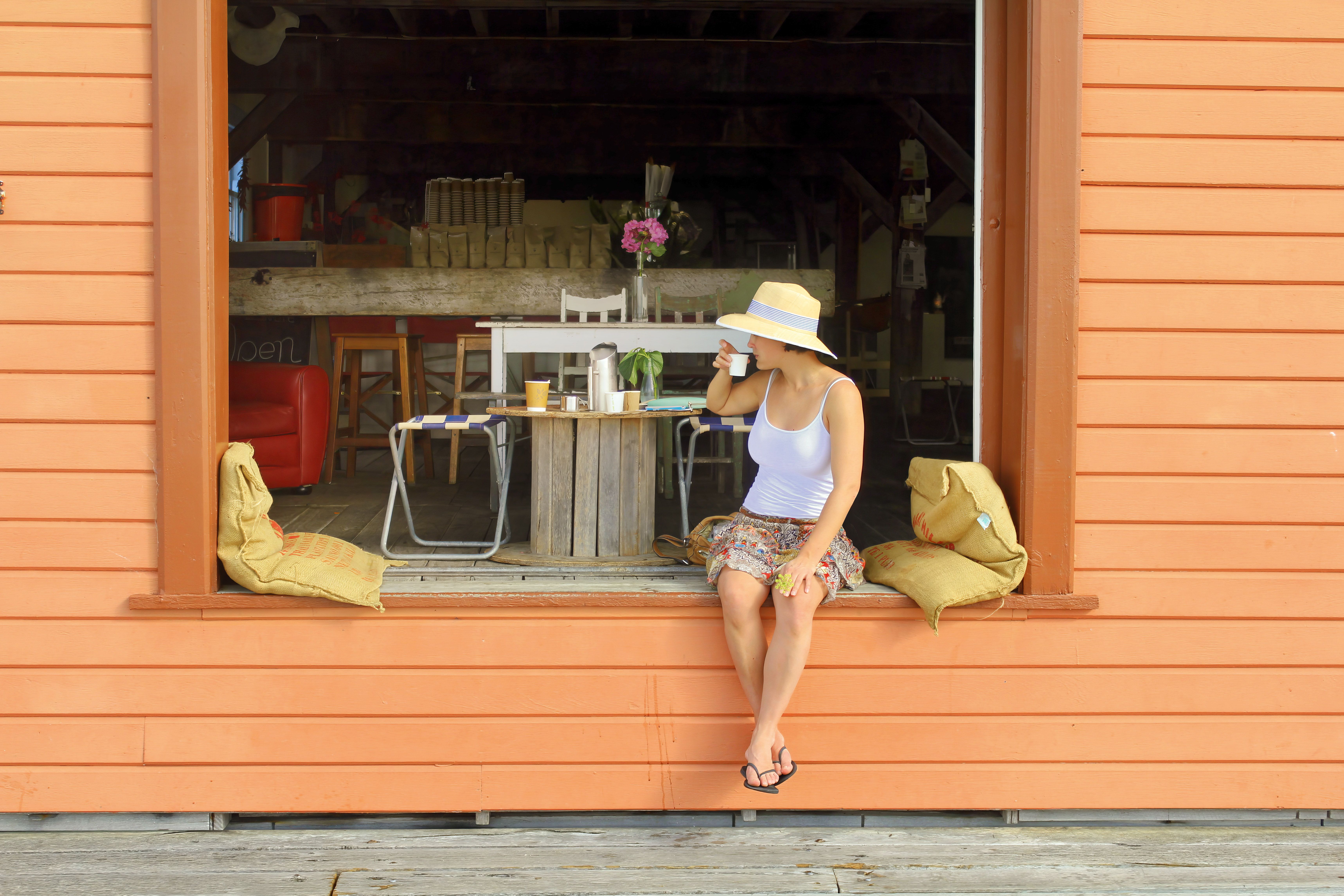 Woman enjoying coffee at an Australian cafe on a sunny day