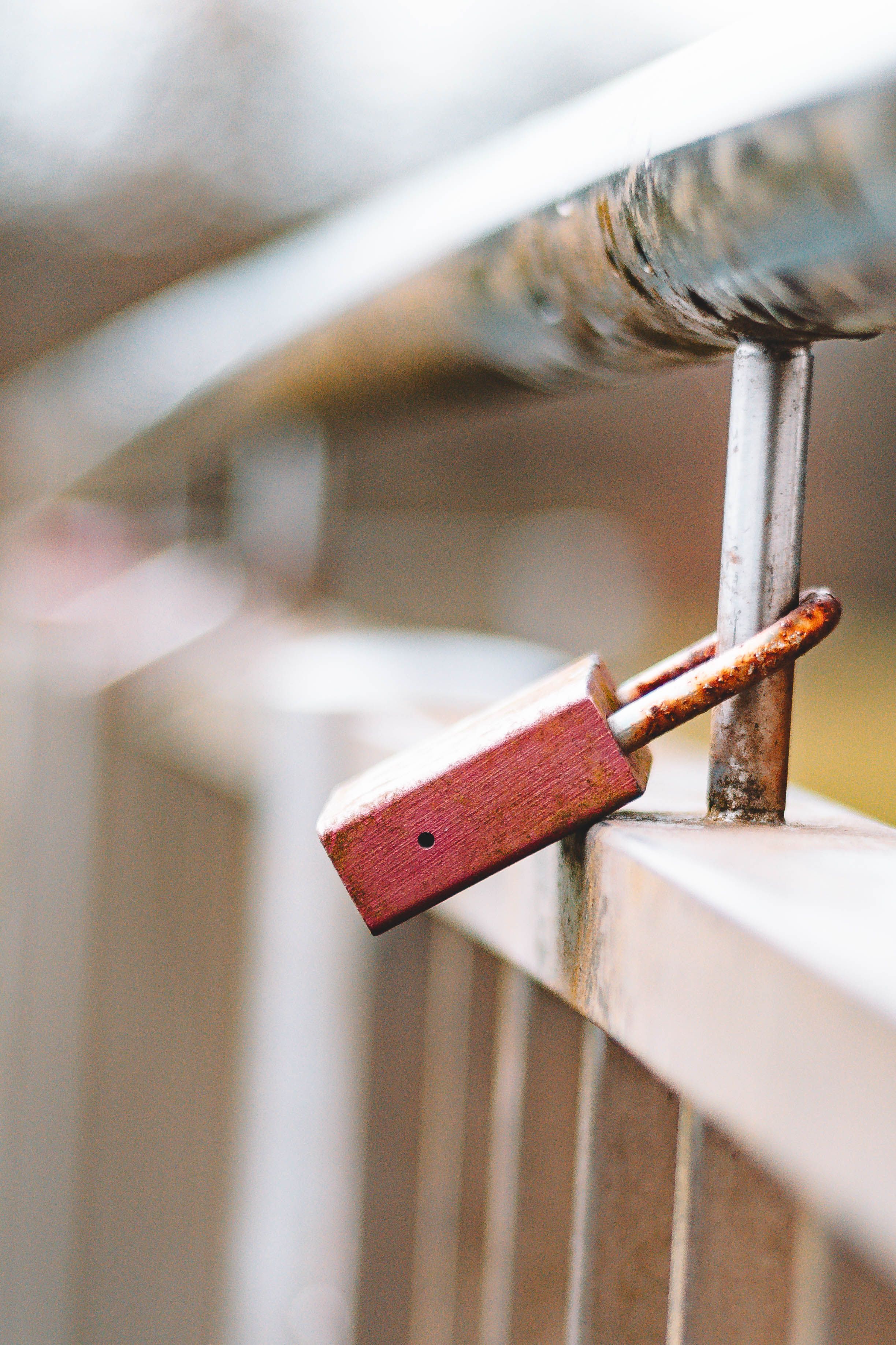 Rusty Padlock on Weathered Metal Railing · Free Stock Photo