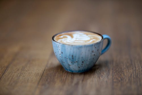 Free Blue Ceramic Coffee Cup on Brown Wooden Surface Stock Photo
