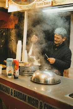 A street vendor prepares traditional ice cream in a bustling market setting.