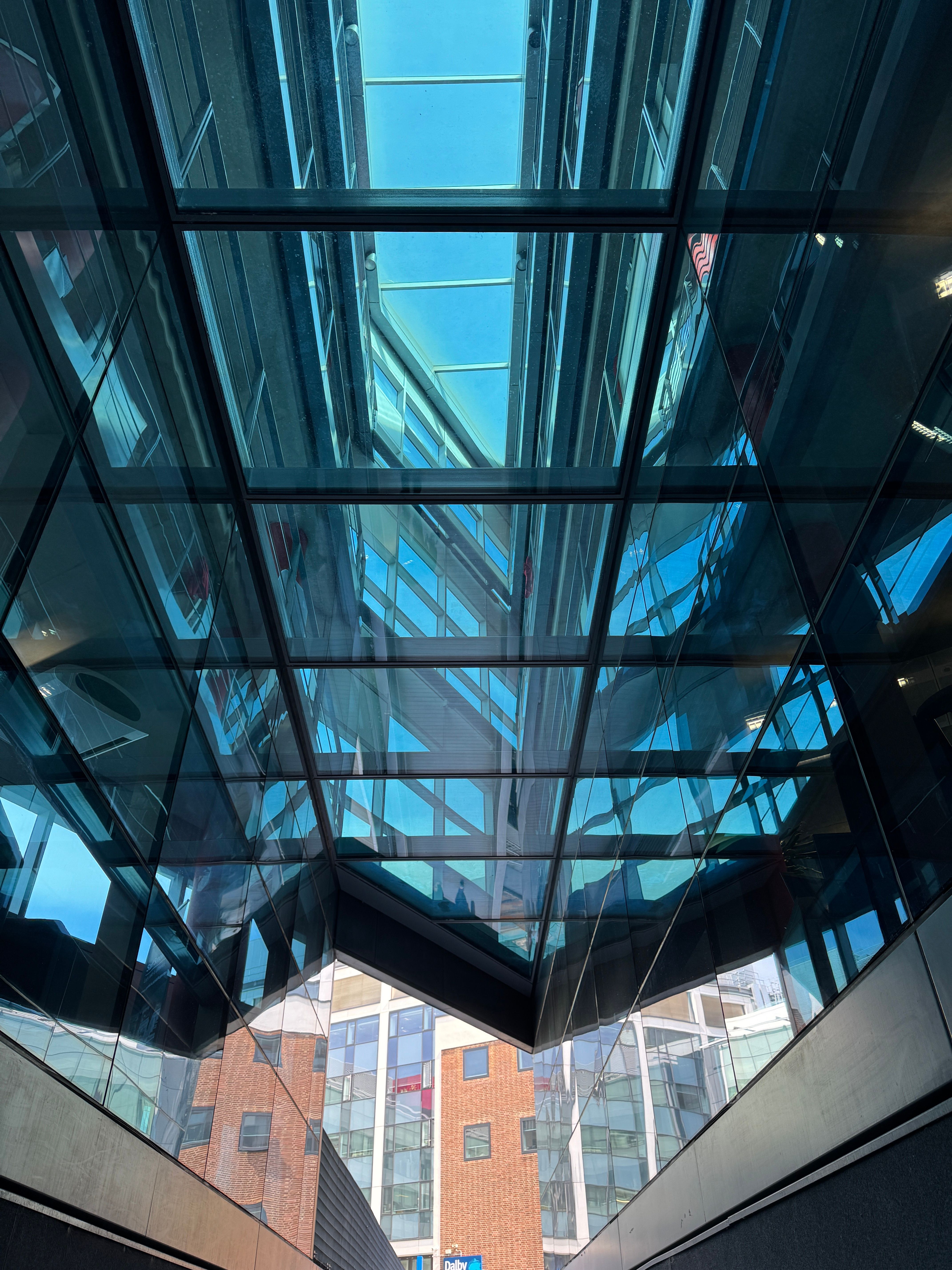 Modern Glass Architecture with Skylight Reflection · Free Stock Photo