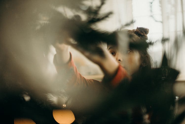 Girl Decorating A Christmas Tree