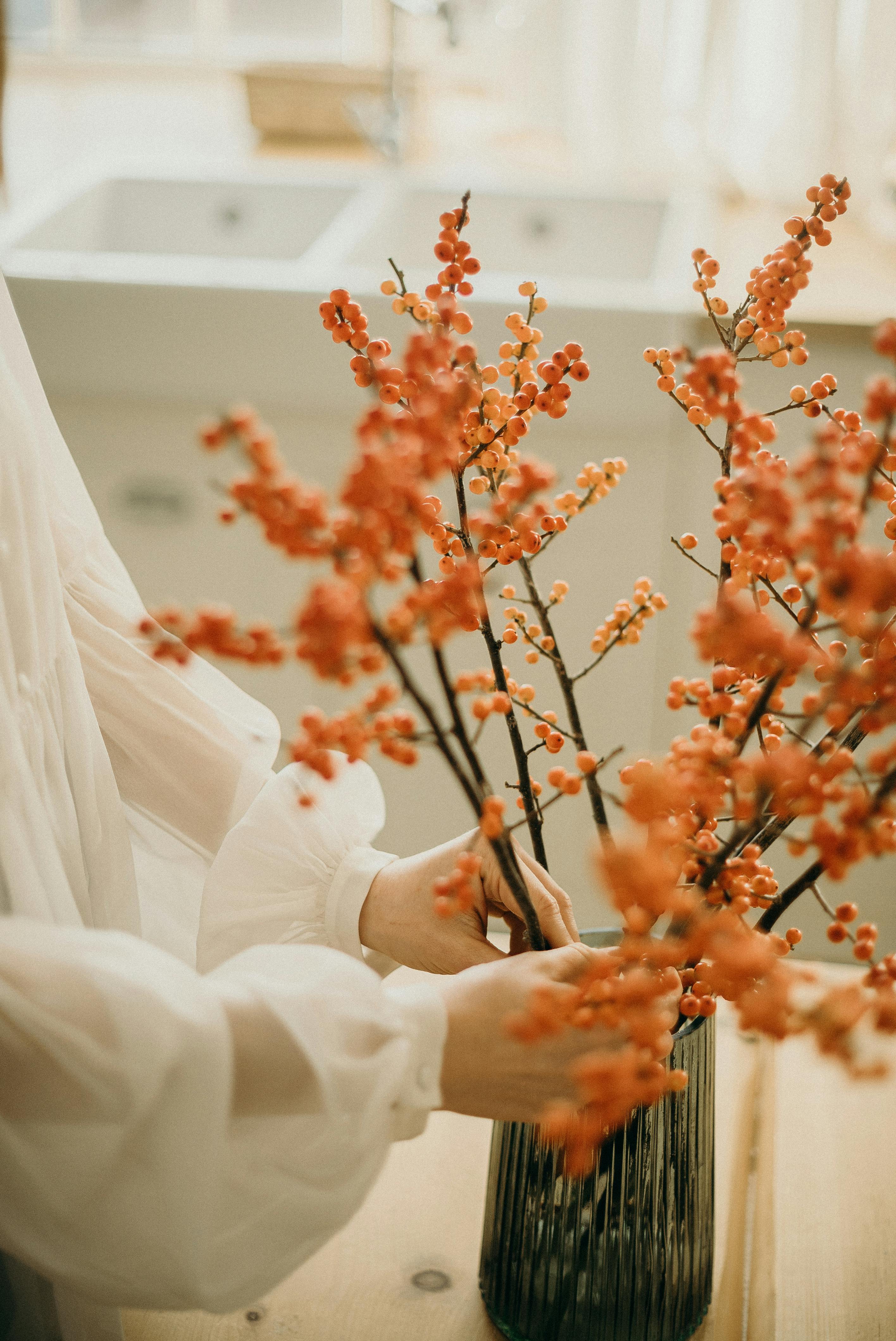 woman arranging flowers on a vase