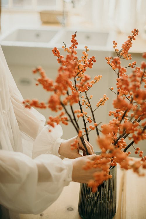 女人在花瓶上插花