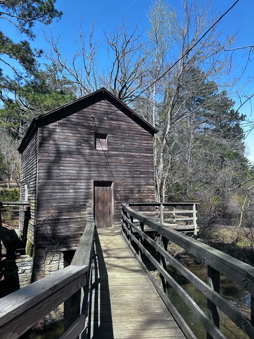 Free A rustic wooden mill with a bridge at Stone Mountain, GA on a sunny day. Stock Photo