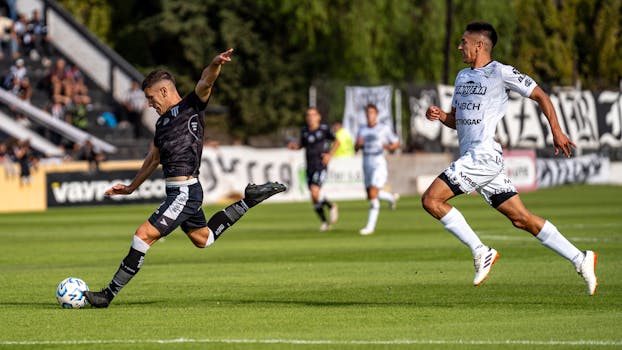 Dynamic scene of soccer players in action during a competitive match on a bright day.