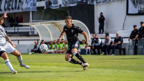 Free Soccer players in action during a competitive match on a sunny day. Stock Photo