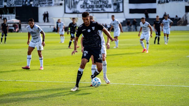 Intense soccer action during a professional match with players in motion.