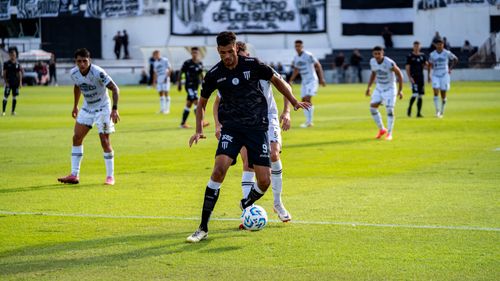Free Intense soccer action during a professional match with players in motion. Stock Photo