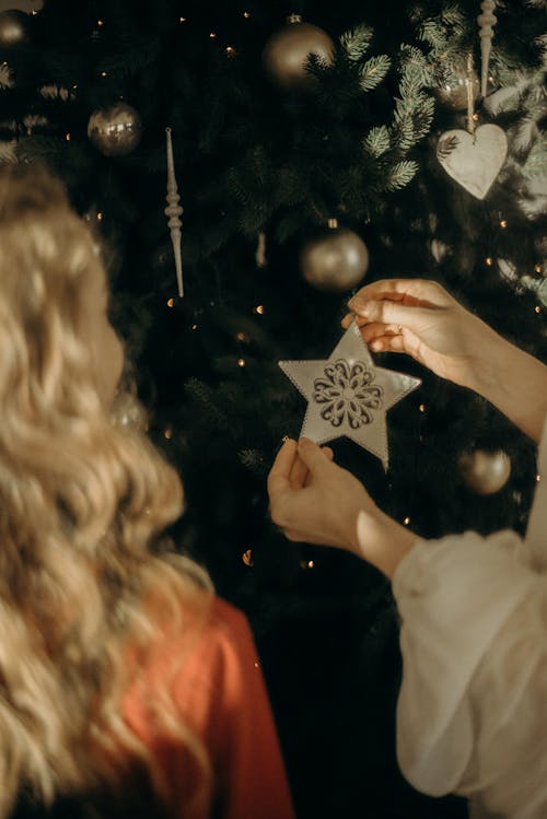 Free Girls Putting Ornaments On A Christmas Tree Stock Photo