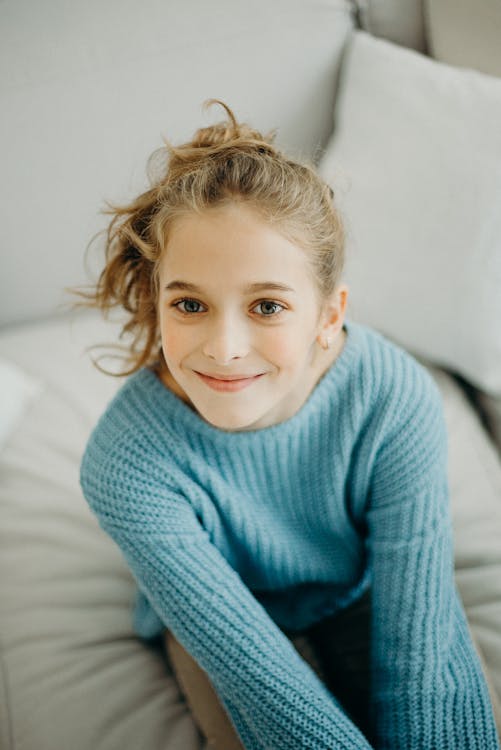 Photo of A Girl Wearing Blue Sweater