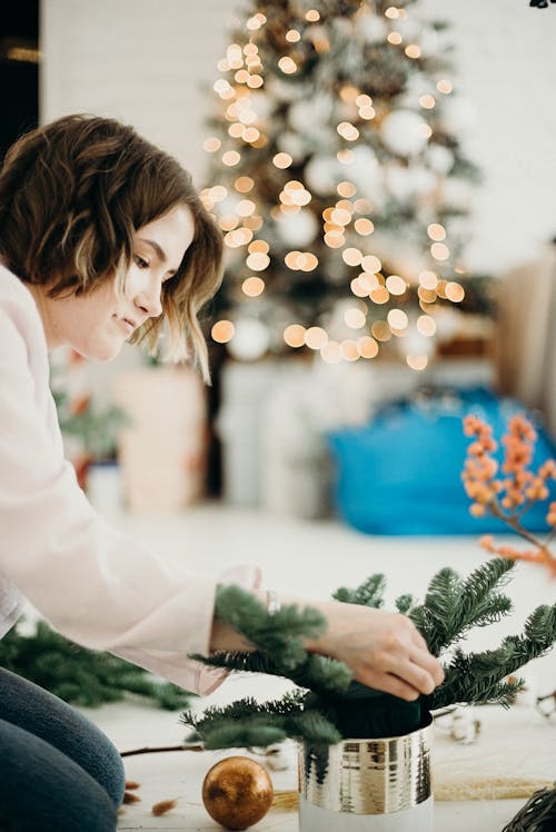 Woman Arranging A Christmas Tree